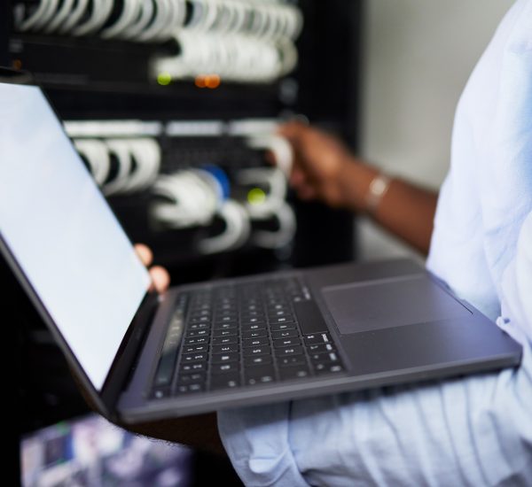 Server room, laptop and IT technician man with internet connection for software programming. Male e